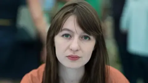 The acclaimed novelist claims she is unable to enter the UK due to legal concerns